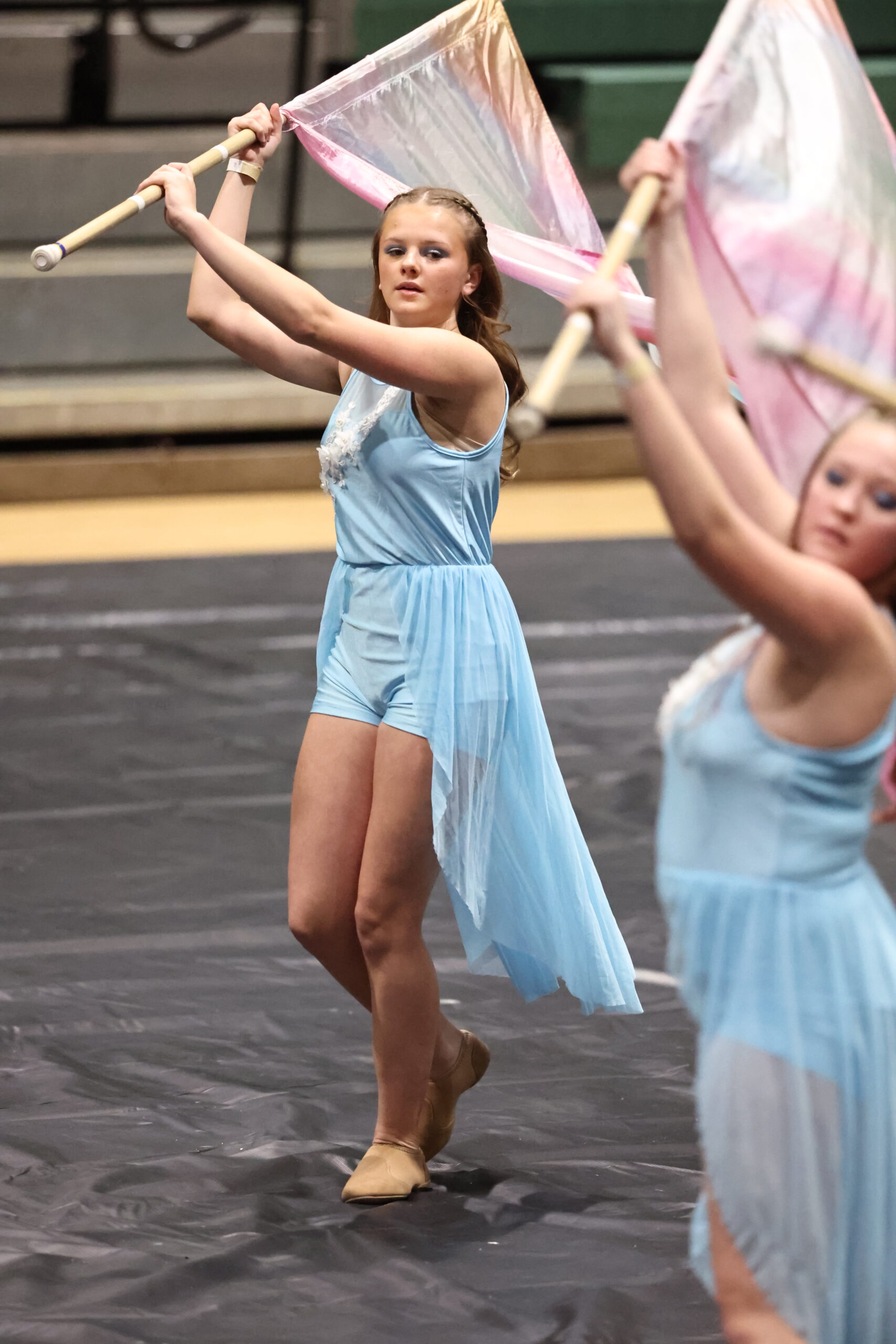 Belding Middle School winter guard member spinning a fire-themed flag